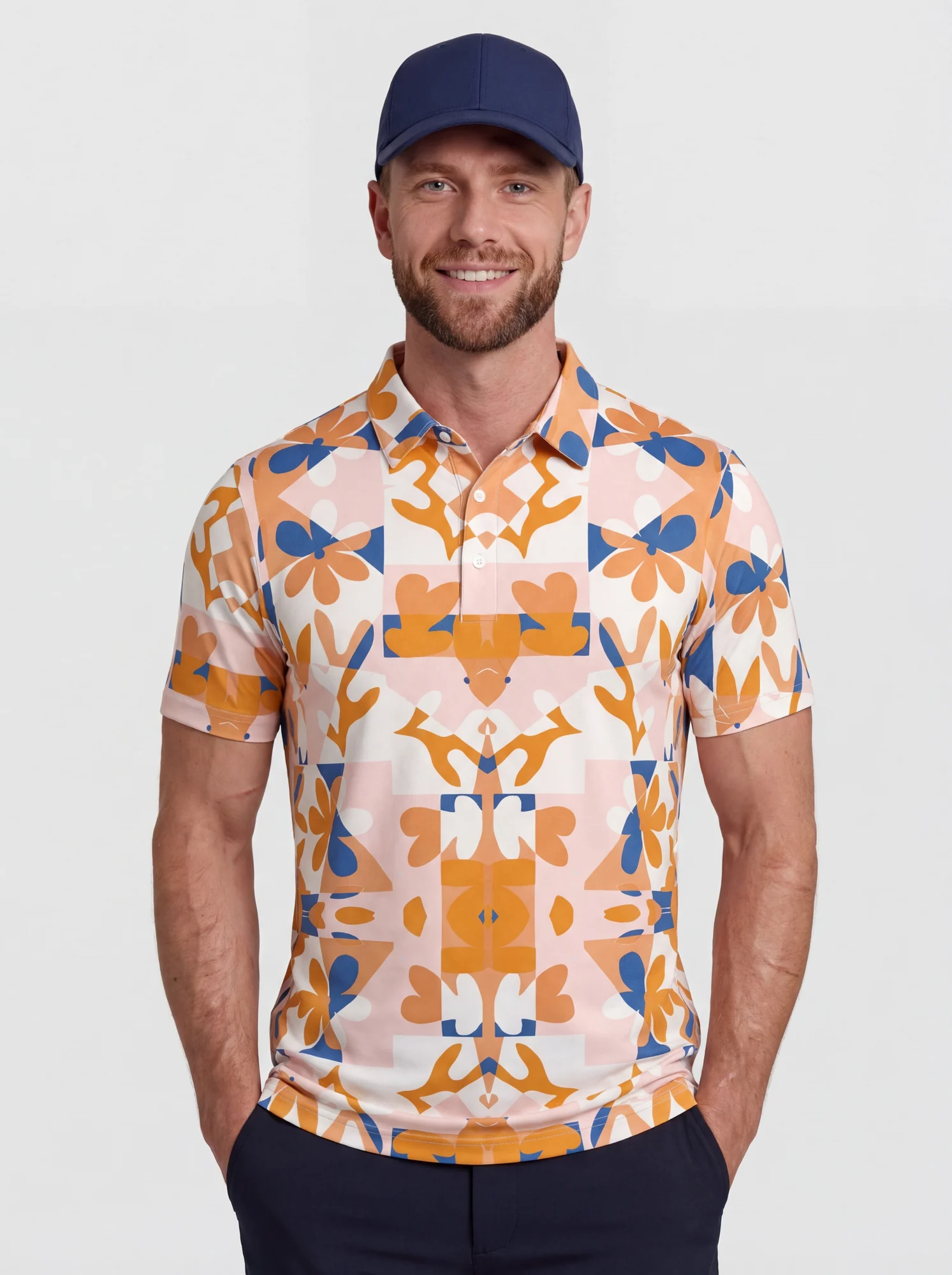 Men's orange retro floral tile print polo in orange / pink / navy / cream, front view