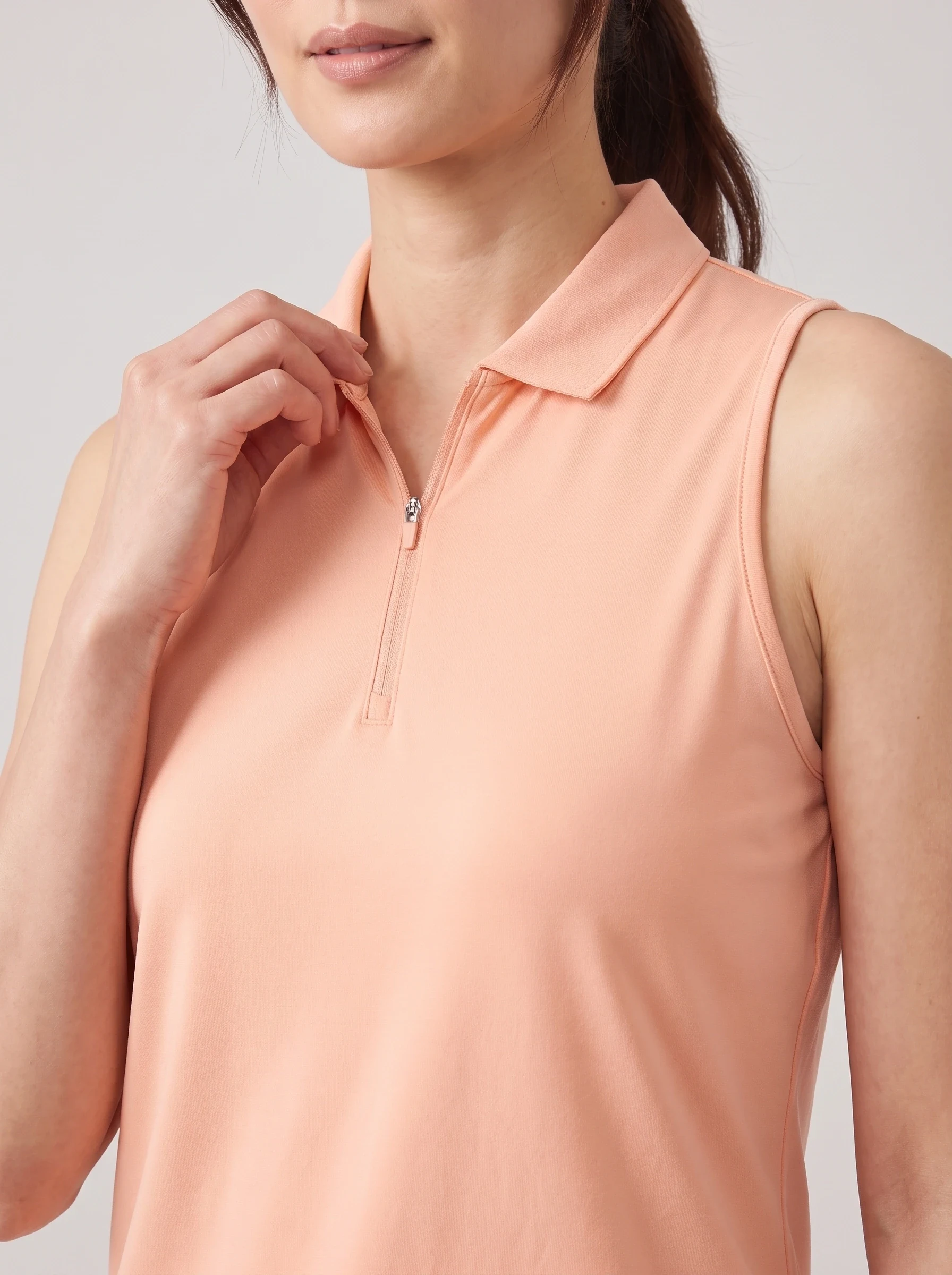 Peach Sleeveless Zip Polo, women solid polos, Sleeveless shoulder join and neck zipper detail