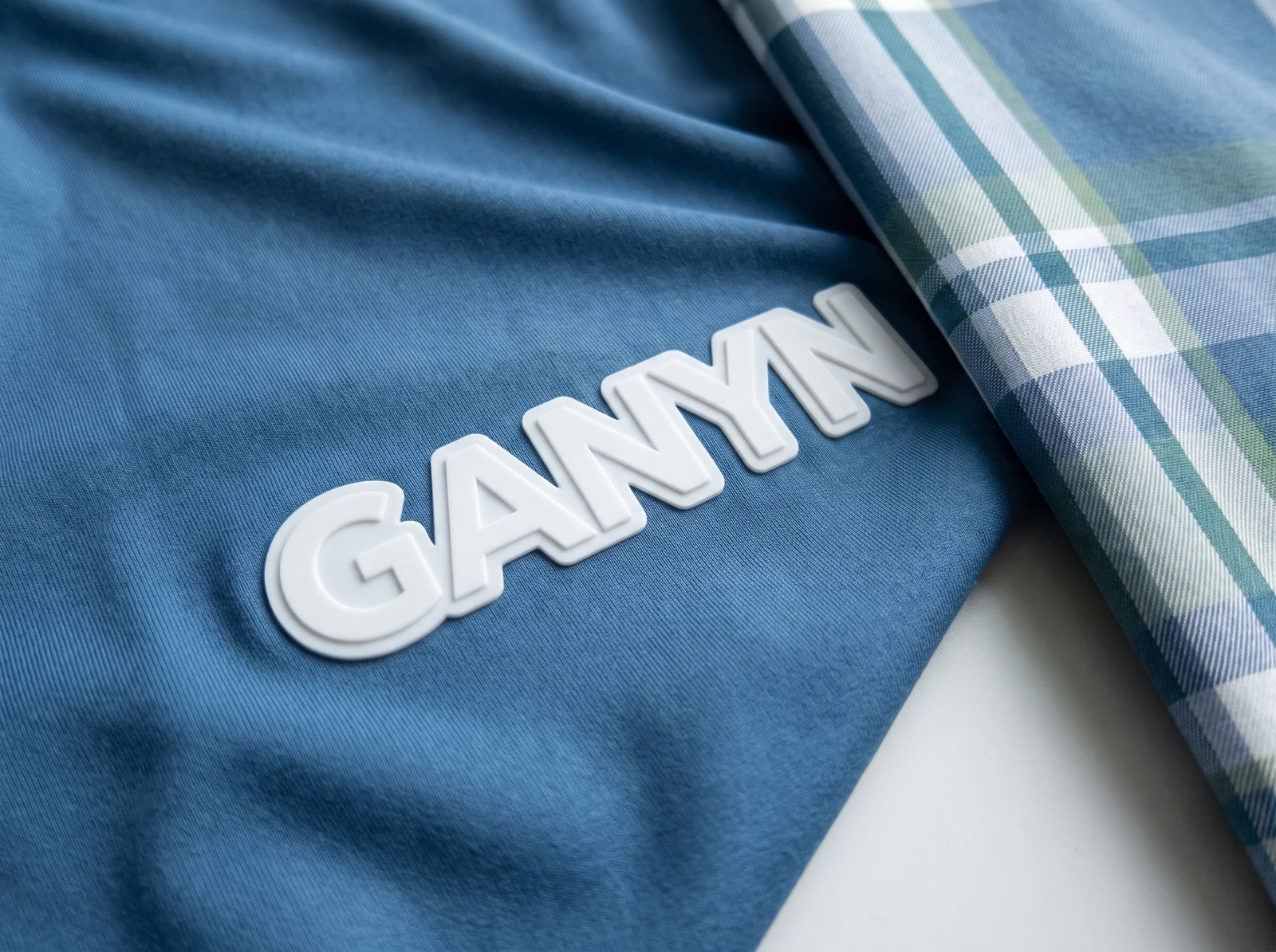 Raised white silicone logo with visible dimensional edges