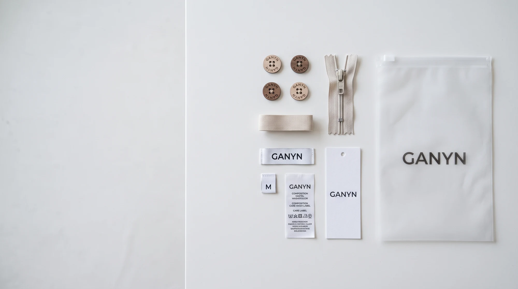 Laser-branded buttons, YKK zipper, GANYN labels, hangtag and printed garment bag